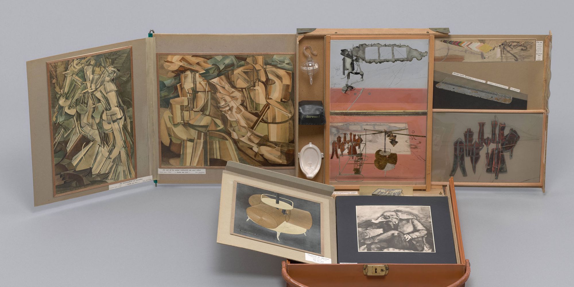 Marcel Duchamp. Box in a Valise (From or by Marcel Duchamp or Rrose Sélavy). 1935–41. Open suitcase displaying a collection of miniature artworks, prints, and objects arranged inside compartments.